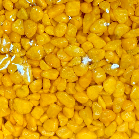 Close-up of yellow pebbles with a clear background